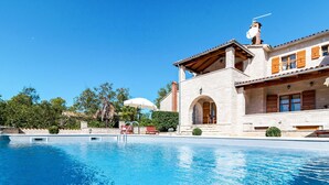 A swimming pool with a stone building in the background. - Villa Sand by Interhome (Poreč)