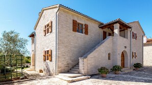 A stone building with a balcony, a staircase, and potted plants. - Villa Sand by Interhome (Poreč)
