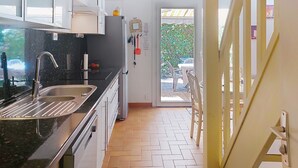 A modern kitchen with a sink, stove, and cabinets. - Tiny Blue by Interhome (La Motte en Provence)