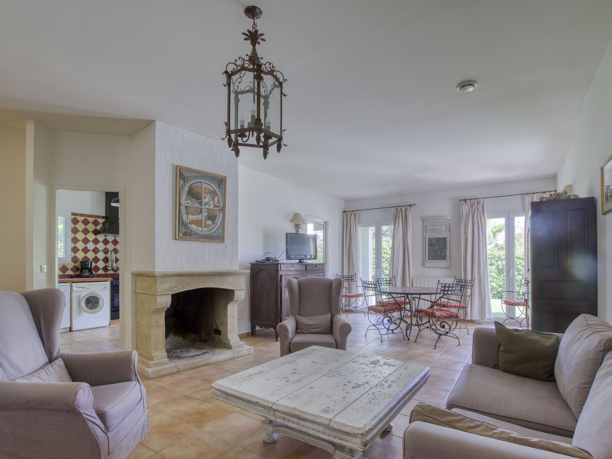 A spacious living room with a fireplace, comfortable seating, and a dining area.