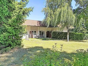 A two-story house with a tiled roof, a front porch, and a well-maintained lawn. - Lenzer Höh by Interhome (Plau am See)