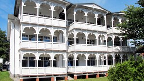 A multi-story building with a symmetrical facade, featuring arched windows and balconies on each floor. - Juliusruh by Interhome (Juliusruh)