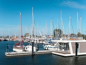 Moored boats line the marina's piers, offering a tranquil waterfront scene.
