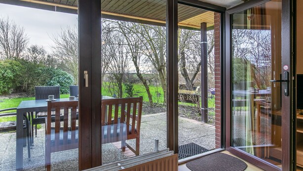 A modern room with a sliding glass door leading to a patio area. - Nordsee-Ferienhaus by Interhome (Friedrichskoog)