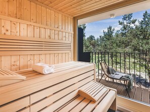 A wooden sauna with a bench and a bench with a towel. - Mariandl am Meer by Interhome (Ostseebad Binz)