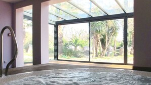 A spa room with a hot tub, large windows, and a view of the outdoors. - Le Mediterranée by Interhome (Argelès sur Mer)