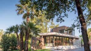 A modern house with a stone facade, large windows, and a well-maintained lawn. - Le Mediterranée by Interhome (Argelès sur Mer)