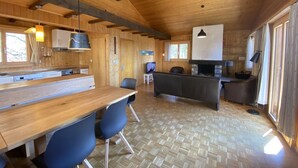 A wooden interior with a kitchen, dining area, and seating space. - Chalet Soldanella (BEL205) by Interhome (Bellwald)