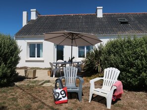 Guests can enjoy a shaded seating area with a table and two chairs.