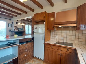 A kitchen with wooden cabinets, a built-in oven, and a tiled backsplash.