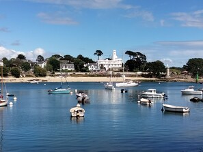 A coastal town with a lighthouse, boats, and houses along the shore. - Breizh Riviera by Interhome (Bénodet)