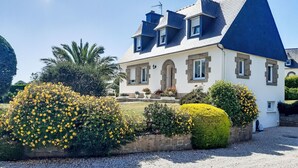 A large, white building with a steeply pitched roof and stone accents. - Gueradur by Interhome (Pleumeur Bodou)
