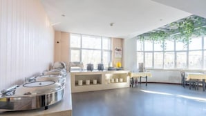 A modern dining area with a buffet setup, large windows, and a ceiling garden. - Yanhong Hotel (Jiayuguan Xiongguan Plaza) (Jiayuguan)