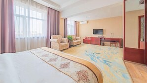 A hotel room with a large bed, a desk, a chair, a television, and a wardrobe. - Yanhong Hotel (Jiayuguan Xiongguan Plaza) (Jiayuguan)