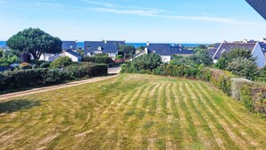 A residential area with houses, a well-maintained lawn, and a clear view of the sea. - de la Plage by Interhome (Pleubian)