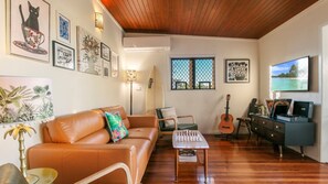 Relax in this stylish living room with a sofa, coffee table, and wall-mounted TV.