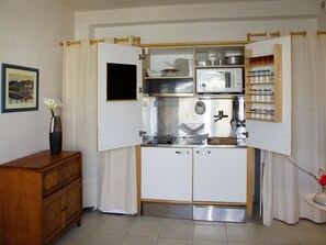 Enjoy cooking in this fully equipped kitchen with microwave and oven, stainless steel sink, and ample storage.
