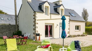 A house with a patio area featuring outdoor furniture and a barbecue. - Va Zi Bihan by Interhome (Guissény)