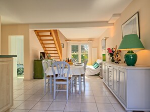 Enjoy meals in this elegant dining area with a large table, comfortable chairs, and a beautiful view.
