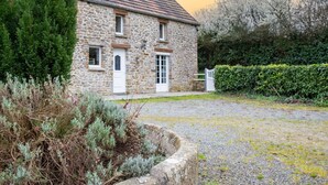 A stone house with a tiled roof, a front door, and a gravel driveway. - Les Mésanges by Interhome (St. Lo-d'Ourville)