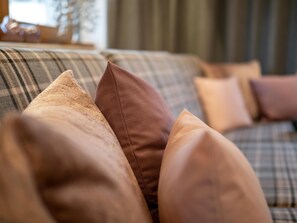 A close-up of a sofa with multiple cushions.