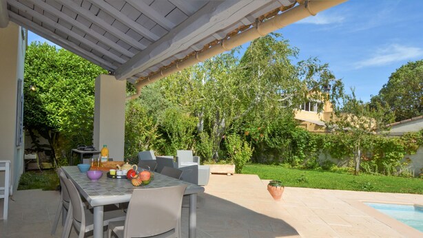 An outdoor patio with a dining table, chairs, and a pool. - A qui sian ben by Interhome (L'isle sur la Sorgue)