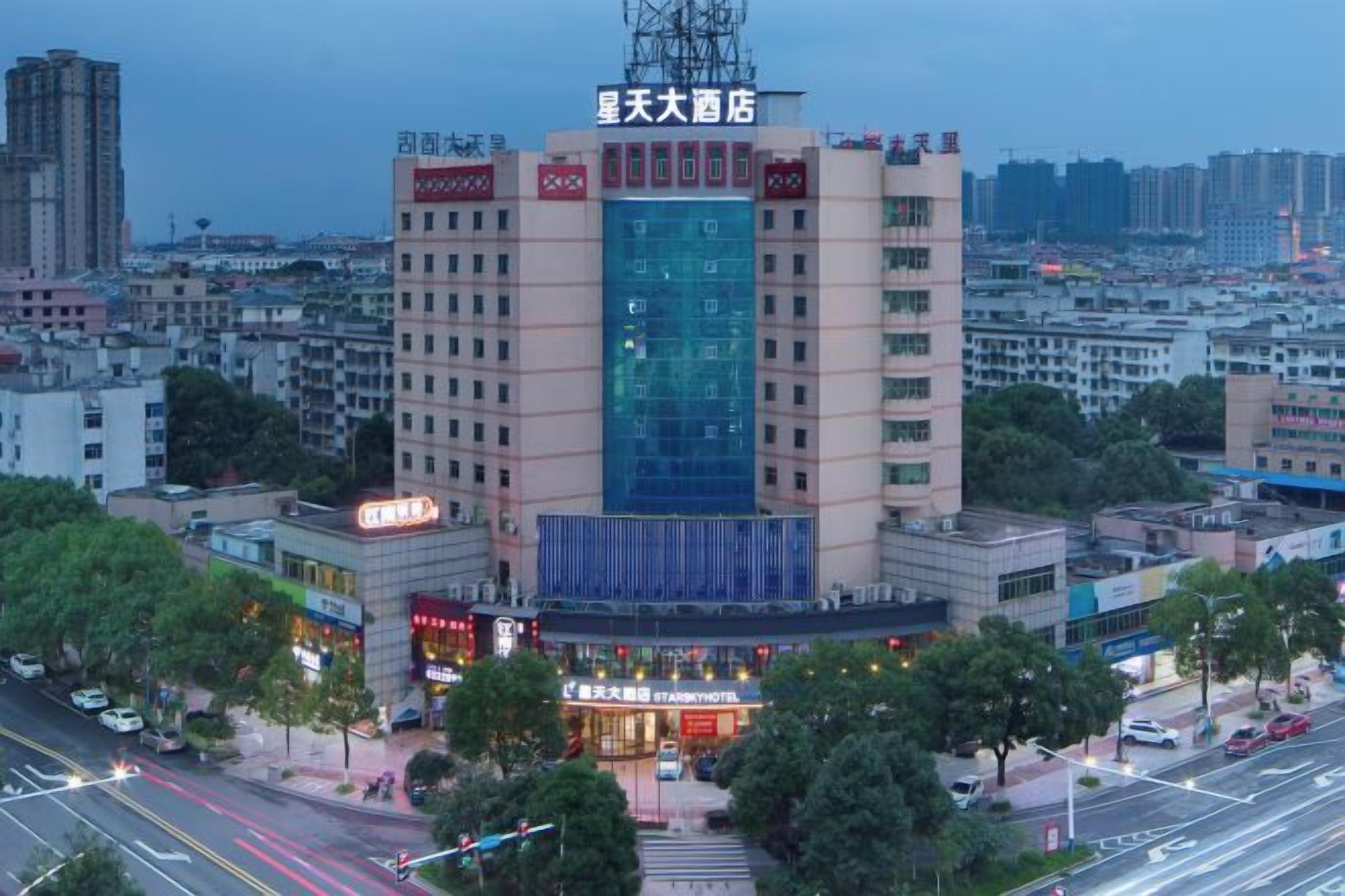 A hotel with a prominent central tower, surrounded by a cityscape.