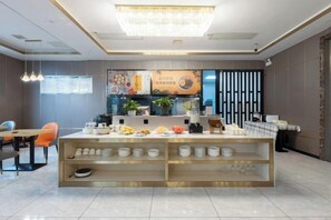 A modern interior with a central counter, seating area, and a decorative chandelier. - Star Sky Hotel (Pingjiang)