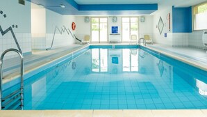 A large indoor swimming pool with clear blue water, tiled walls, and a blue ceiling. - Odalys Référence Le Domaine des Rois by Interhome (Bergheim)