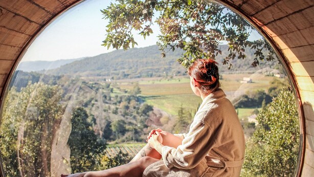 A person sitting on a wooden bench inside a circular room with a view of a valley and hills. - Domaine de Sévenier Chêne Blanc by Interhome (Vallon-Pont-d'Arc)