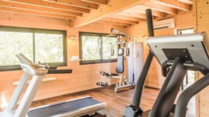 A gym with treadmills, weight machines, and a mirrored wall. - Domaine de Sévenier Chêne Blanc by Interhome (Vallon-Pont-d'Arc)