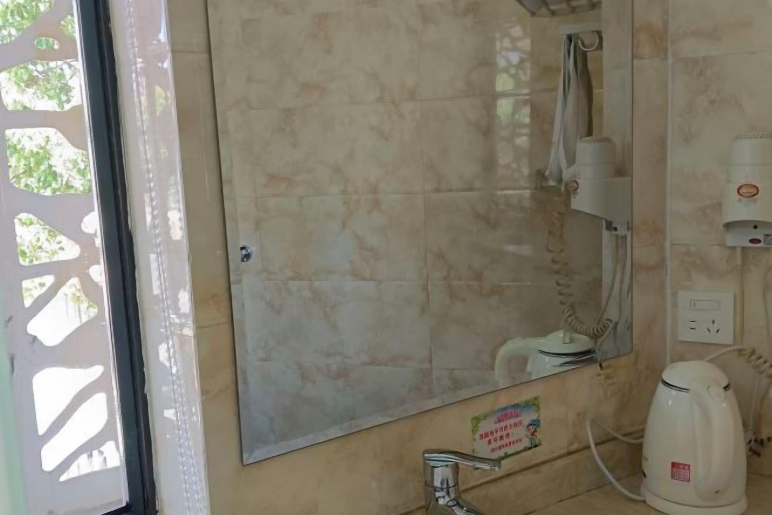 A bathroom with a sink, mirror, and a towel rack.
