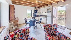 A modern kitchen with a built-in microwave, a dishwasher, and a large window. - Vacation home Cuzac by Interhome (Labastide-Murat)