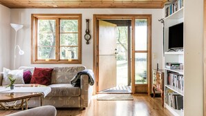 A cozy living room with a sofa, a coffee table, and a bookshelf.