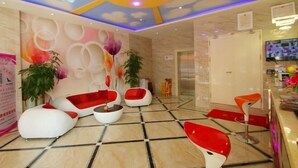 A lobby with a modern design, featuring a mix of seating areas and a reception desk. - Light Stay·Noli Theme Hotel (Shanghai Fengxian Nanqiao Branch) (Shanghai)