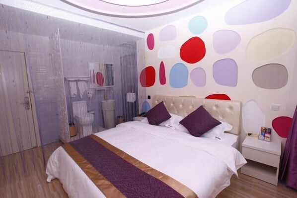 A modern bedroom with a large bed, a bedside table, and a wall with abstract shapes. - Light Stay·Noli Theme Hotel (Shanghai Fengxian Nanqiao Branch) (Shanghai)