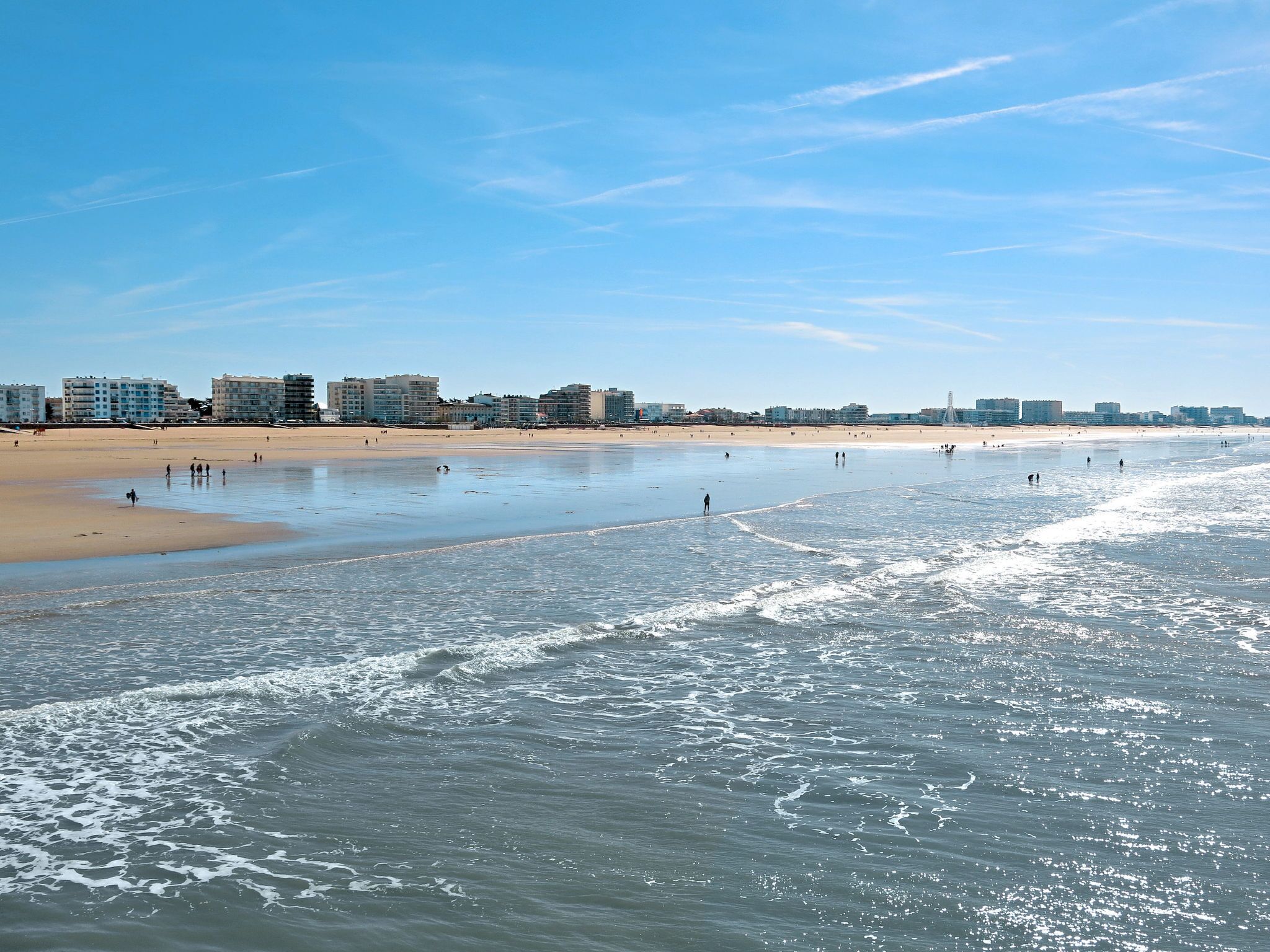A beach with buildings in the background.