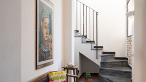 A staircase with a black railing leading to a landing. - Costanza & Valeria (PRE133) by Interhome (Molini di Prelà)