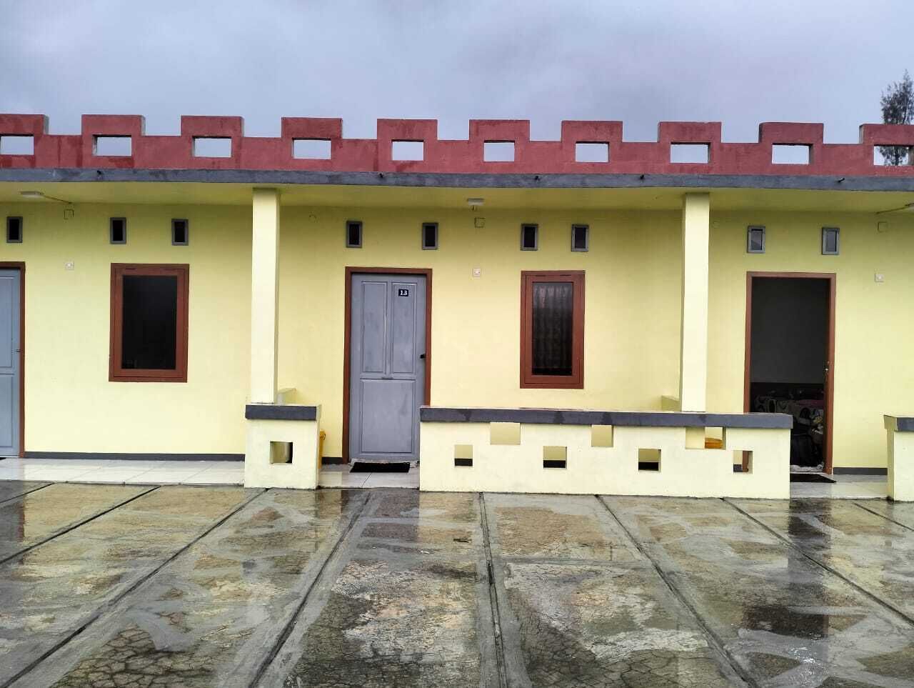 A building with a flat roof, multiple doors, and windows.