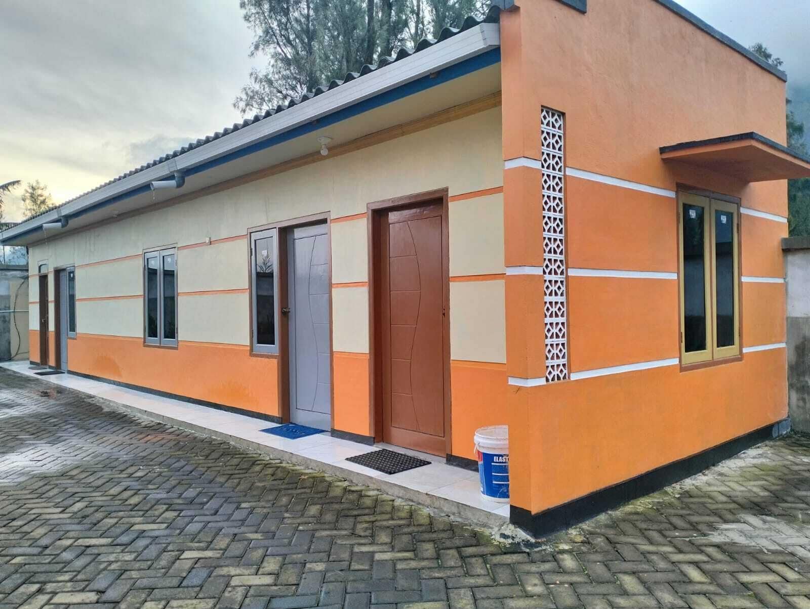 A single-story building with a flat roof, a door, and windows.