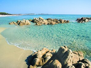 A beach with clear turquoise water, rocky formations, and a sandy shore. - Cala Viola by Interhome (Orosei)