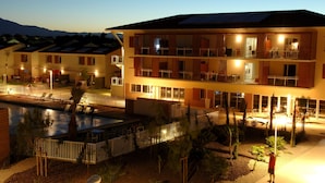 A multi-story hotel with balconies, a swimming pool, and a well-lit outdoor area. - Demeures de la Massane 2P4 pers by Interhome (Argelès sur Mer)