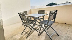 A small outdoor patio with a table and four chairs. - La Dune by Interhome (Valras Plage)