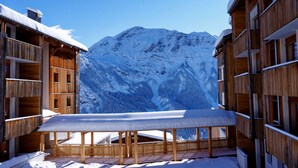 A snow-covered wooden building with a balcony overlooking a snowy mountain. - Etoiles d'Orion by Interhome (Orcières-Merlette)