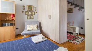 A bedroom with a bed, a wardrobe, a desk, and a chair. - La Rondine (LUU280) by Interhome (Lucca)