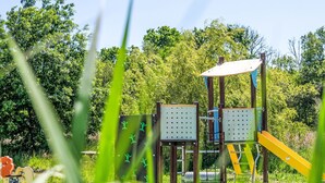 A playground with climbing structures and a slide, surrounded by greenery. - Rés. Odalys Référence Horizon Morgat by Interhome (Crozon-Morgat)