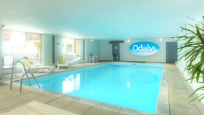 An indoor swimming pool with lounge chairs and a sign for 'Odaly Vacances'. - Odalys Référence L'Ours Blanc by Interhome (Les Deux Alpes)