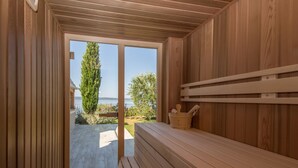 A sauna room with wooden walls and a bench. - Villa Bugenvila by Interhome (Ugljan/Ugljan)