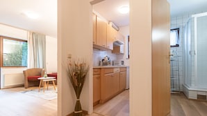 A modern apartment with a living area, kitchen, and bathroom.