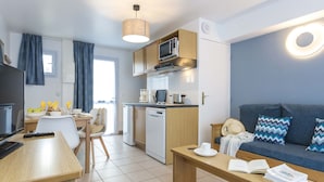 Een modern, licht appartement met keuken, eethoek en woonkamer.